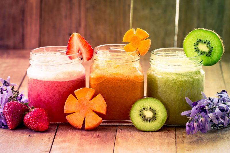 Sweet color of mix fruit juice blended on wooden background