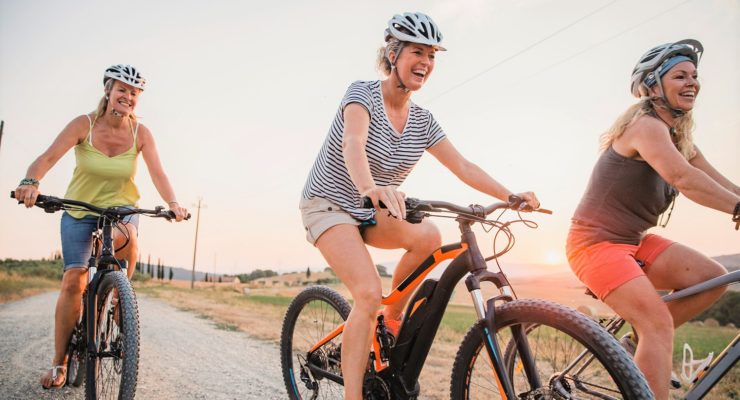 three women going for a bike ride in the summer