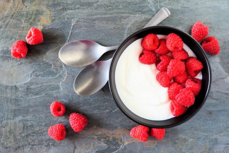 Greek yogurt with red raspberries in a bowl