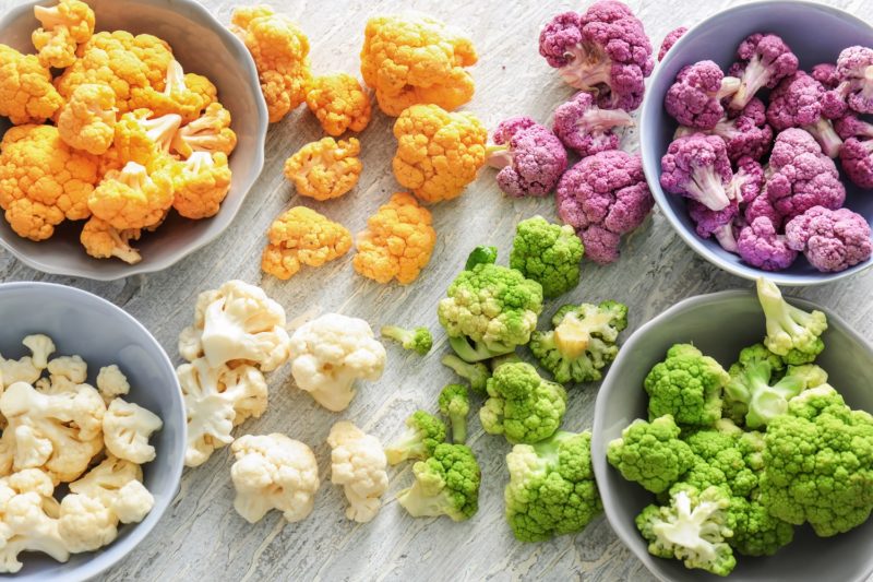 colorful cauliflower in four different bowls