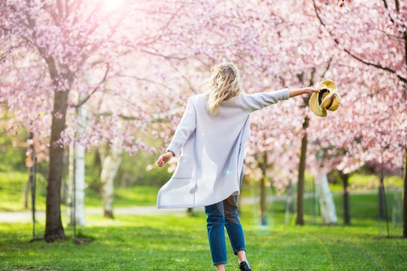 a woman enjoying a walk in the park during spring