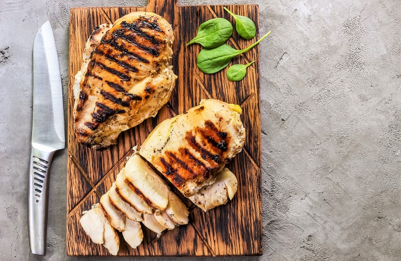 grilled chicken breast on a cutting board