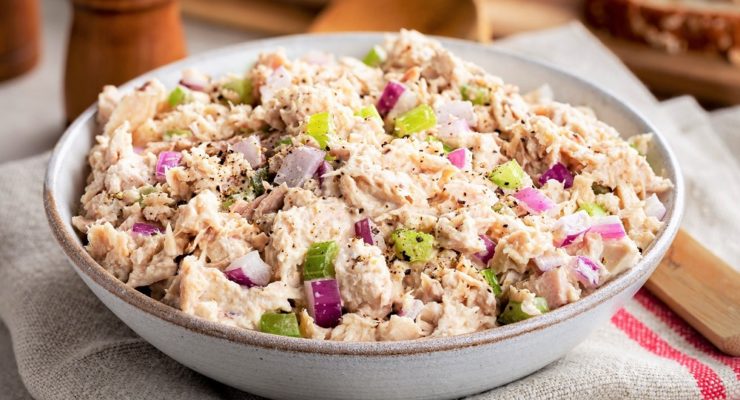 tuna salad with onions and celery in a bowl