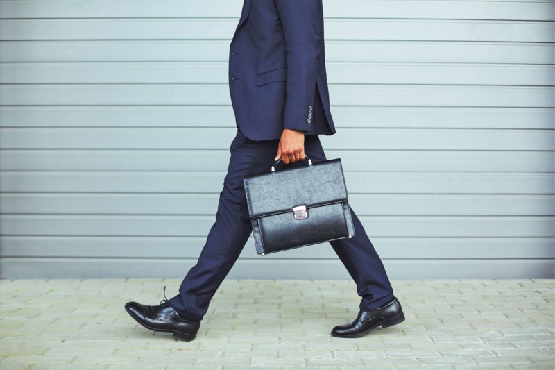 man walking and going back to work with briefcase