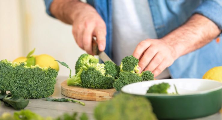 Man chopping broccoli to increase his testosterone levels