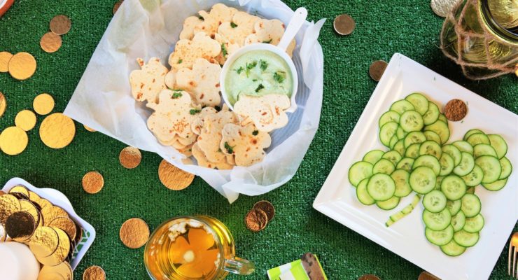Platter of healthy st patricks day snacks on a green surface