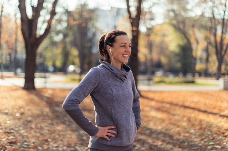 woman outside exercising in fall